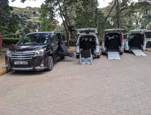 Fleet of wheelchair accessible vans with ramps down in Nairobi