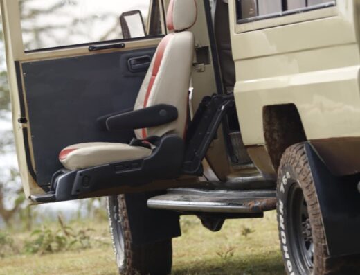 Swivel seat extended and lowered outside a safari Land Cruiser for an easy transfer