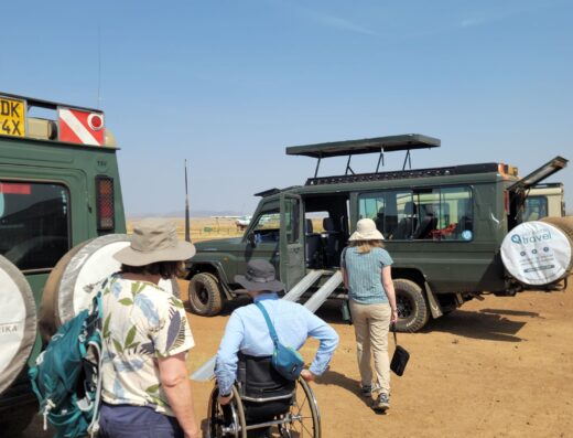Wheelchair user heading to a ramp-equipped Land Cruiser in the Maasai Mara